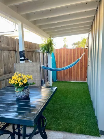 a view of outdoor dining space with a table and chairs