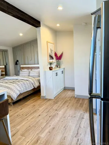 a bedroom with a bed mirror and a sink