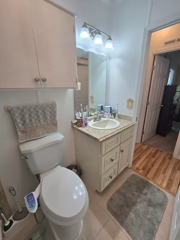 a front view of a house with a garden and trees