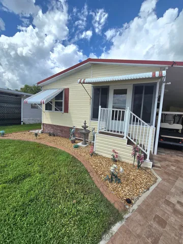 a view of front door and deck in the backyard