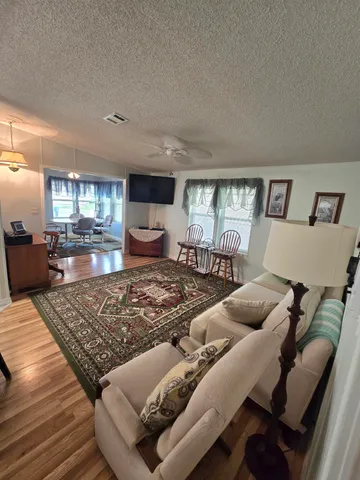 a living room with furniture and a wooden floor