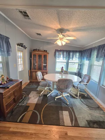 a dining room with furniture and window