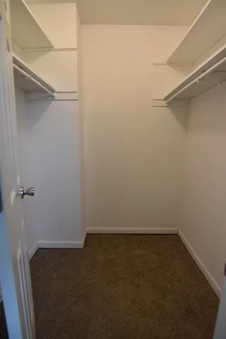 a bathroom with a granite countertop toilet sink and mirror