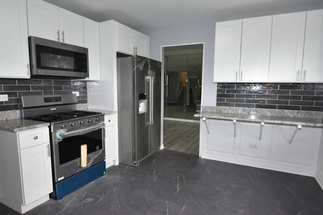 a kitchen with a stove and a refrigerator