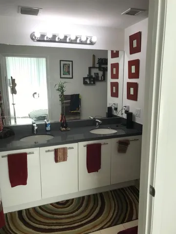 a bathroom with a sink a double vanity and a mirror