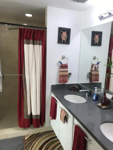a bathroom with a sink toilet a mirror and shower