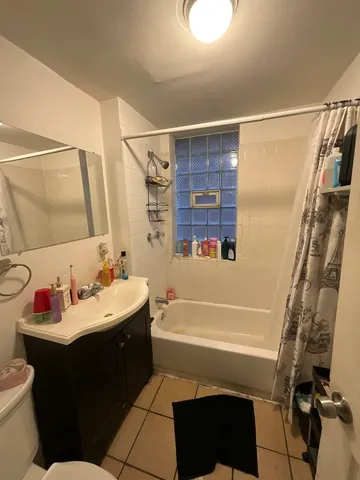 a bathroom with a sink vanity mirror and toilet