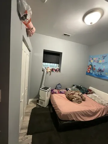 a bedroom with a bed and a chandelier