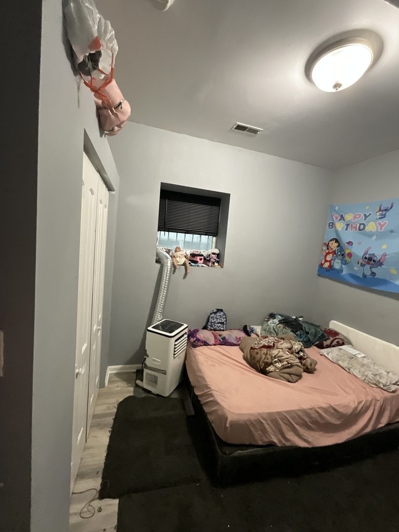 4226 West Ogden Avenue Chicago, IL 60623 - Photo 16 of 20 a bedroom with a bed and a chandelier