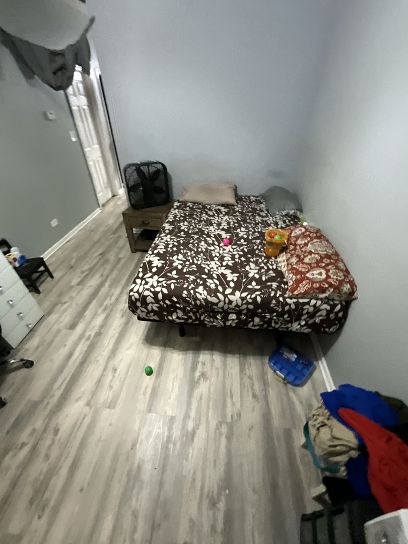 4226 West Ogden Avenue Chicago, IL 60623 - Photo 19 of 20 a bedroom with a bed and a dresser