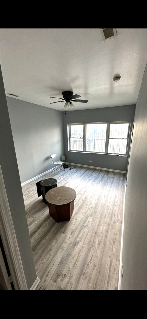 4226 West Ogden Avenue Chicago, IL 60623 - Photo 5 of 20 a view of a room with wooden floor