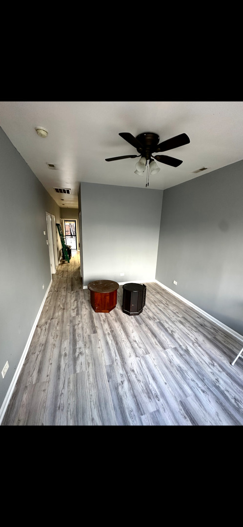 4226 West Ogden Avenue Chicago, IL 60623 - Photo 7 of 20 a view of an empty room with wooden floor