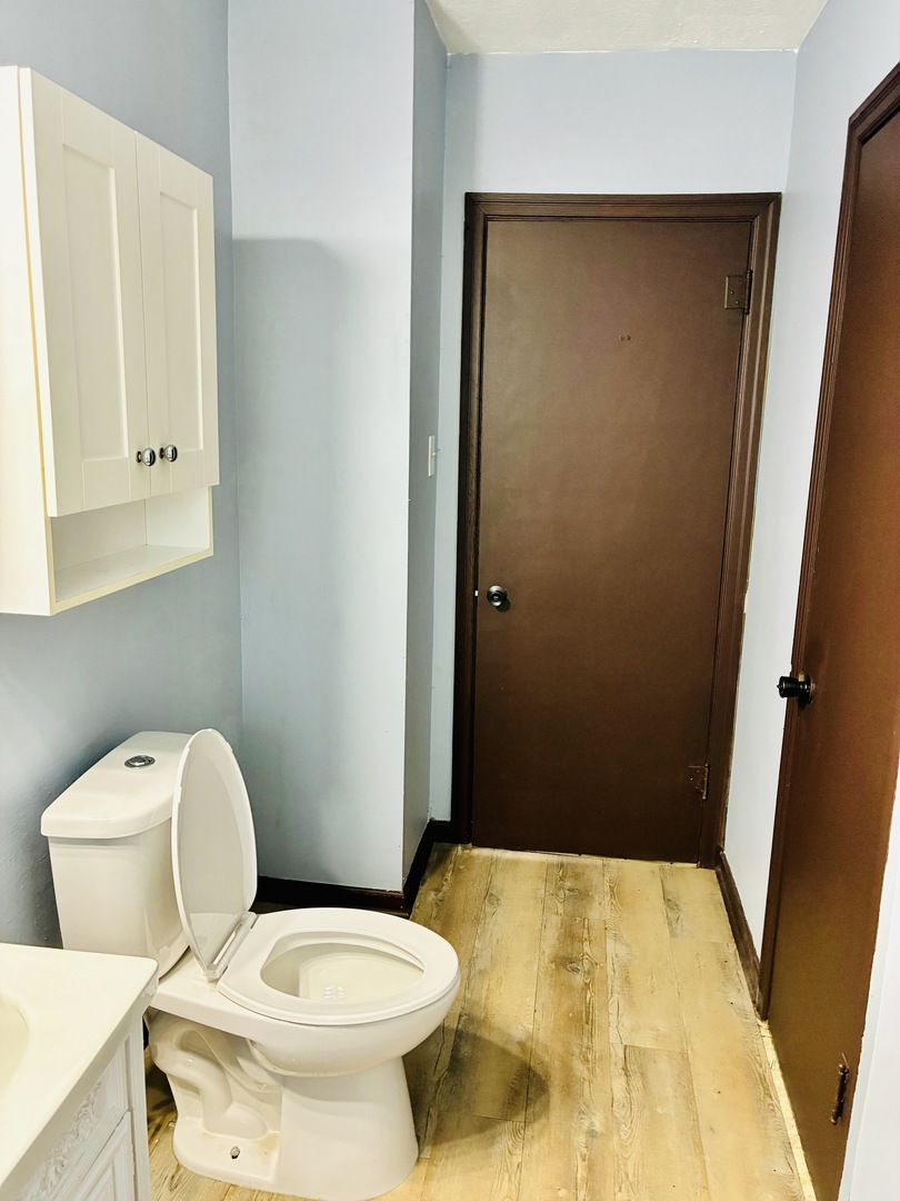 14506 Clinton Street Harvey, IL 60426 - Photo 12 of 12 a bathroom with a toilet and a sink