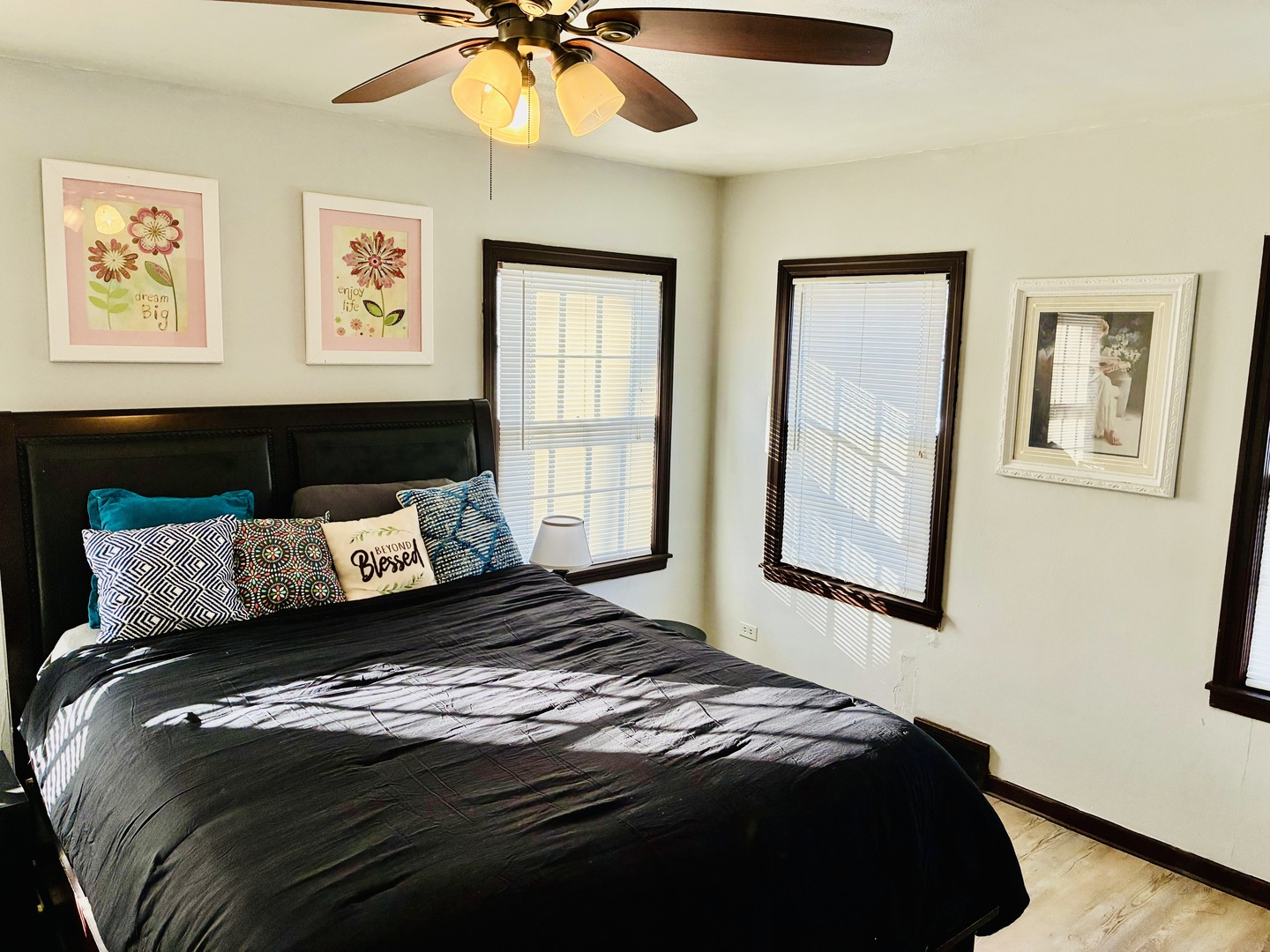 14506 Clinton Street Harvey, IL 60426 - Photo 5 of 12 a bedroom with a large bed and a chandelier