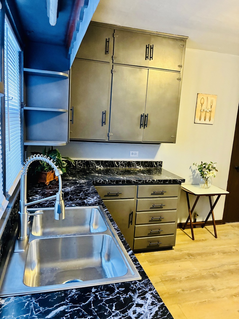 14506 Clinton Street Harvey, IL 60426 - Photo 8 of 12 a kitchen with a sink and a stove top oven