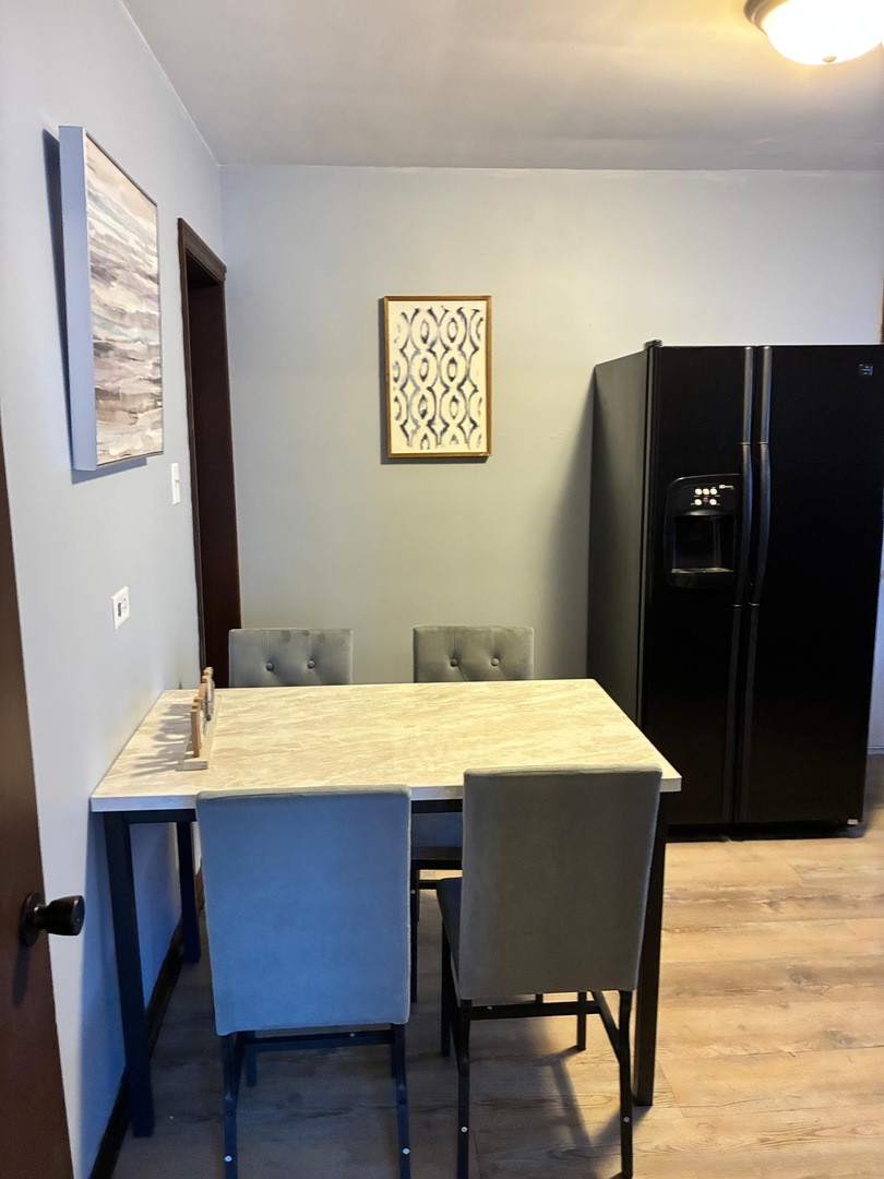 14506 Clinton Street Harvey, IL 60426 - Photo 9 of 12 a dining room with a table and chairs
