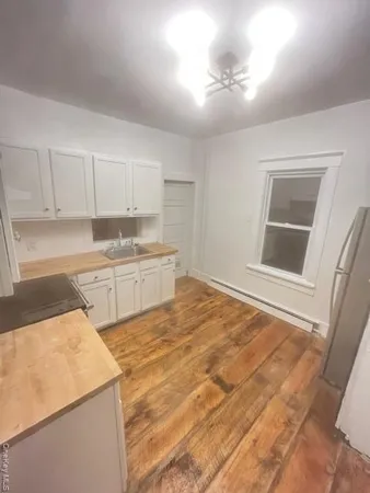 a kitchen with a sink cabinets and window