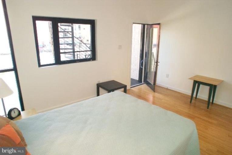 2029 13th Street Northwest, Unit 2 Washington, DC 20009 - Photo 4 of 7 a bedroom with a bed and a window