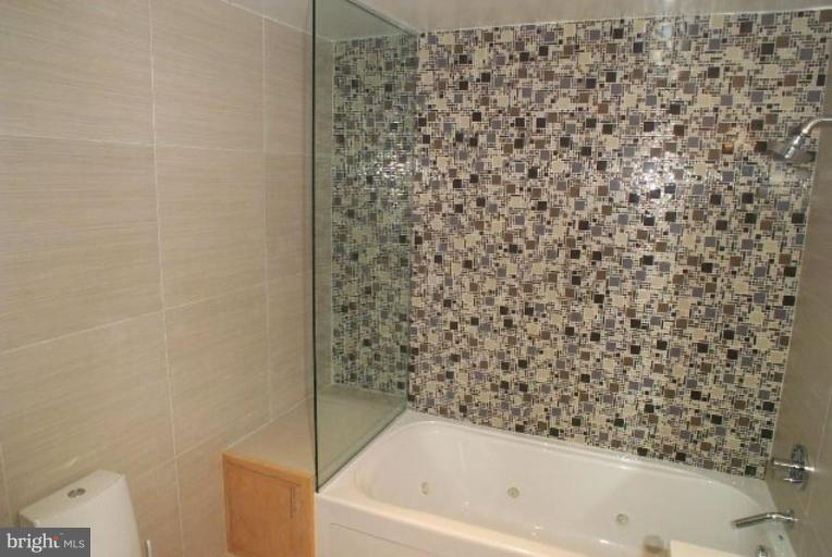 2029 13th Street Northwest, Unit 2 Washington, DC 20009 - Photo 6 of 7 a bathroom with a bathtub and shower