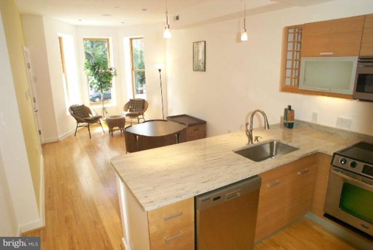 2029 13th Street Northwest, Unit 2 Washington, DC 20009 - Photo 7 of 7 a kitchen with a sink a stove and chairs