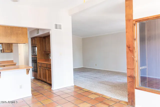 a view of a kitchen from the hallway