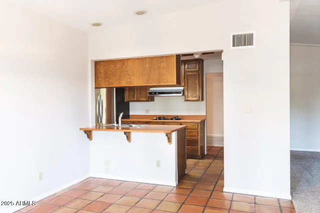 a kitchen with a sink cabinets and appliances