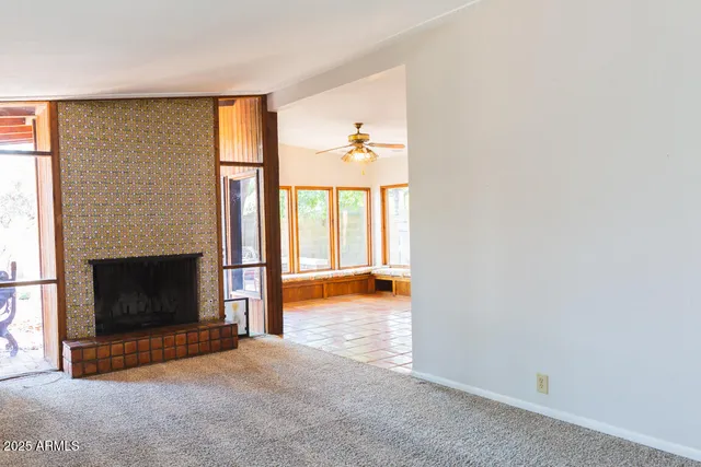a view of a livingroom with a fireplace and a window
