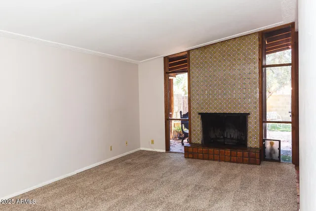 a view of empty room with a fireplace