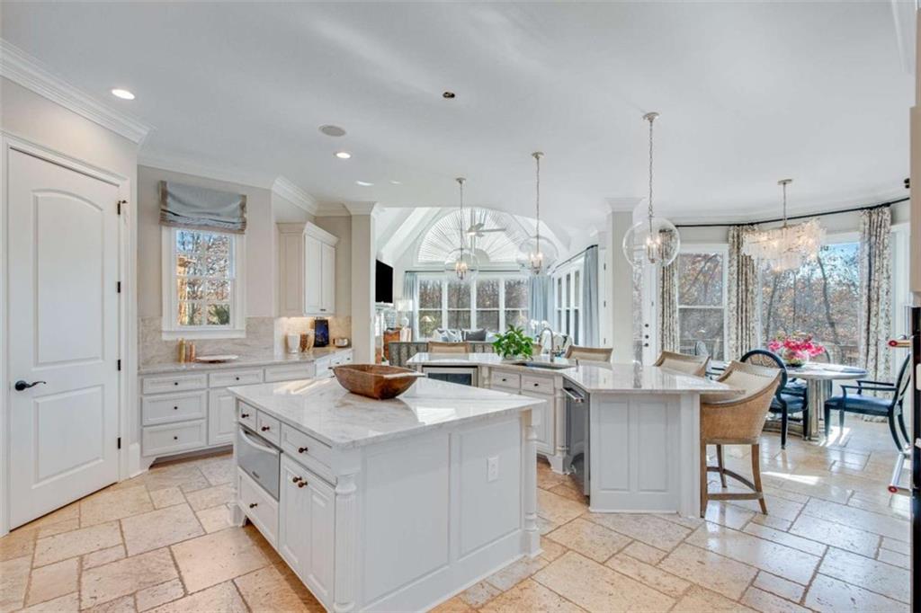 6226 Random Winds Bluff Gainesville, GA 30506 - Photo 15 of 76 a kitchen with sink cabinets and living room view