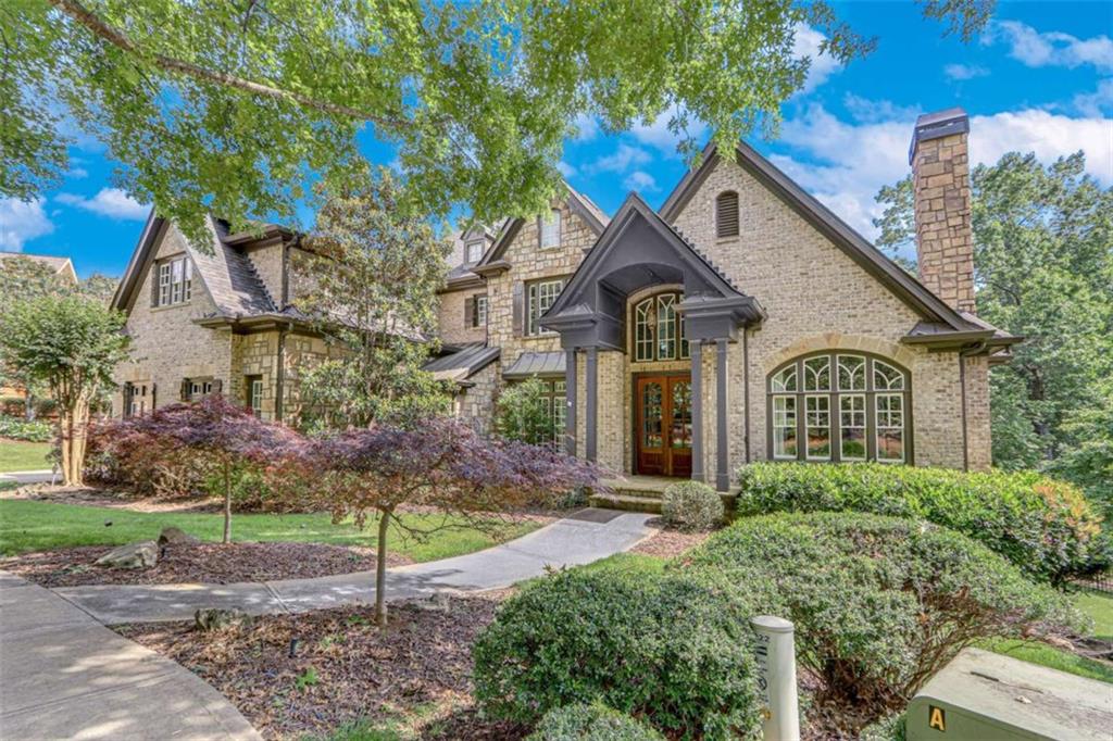 6226 Random Winds Bluff Gainesville, GA 30506 - Photo 2 of 76 a front view of a house with garden