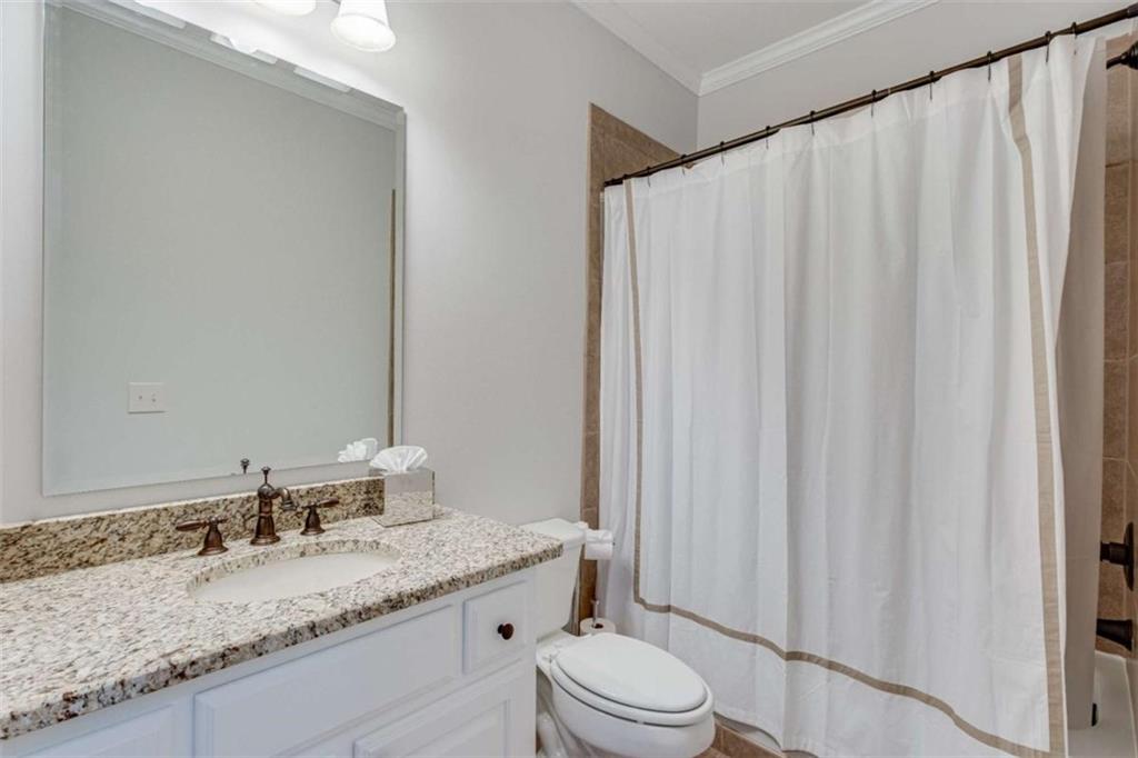 6226 Random Winds Bluff Gainesville, GA 30506 - Photo 40 of 76 a bathroom with a granite countertop sink and a mirror
