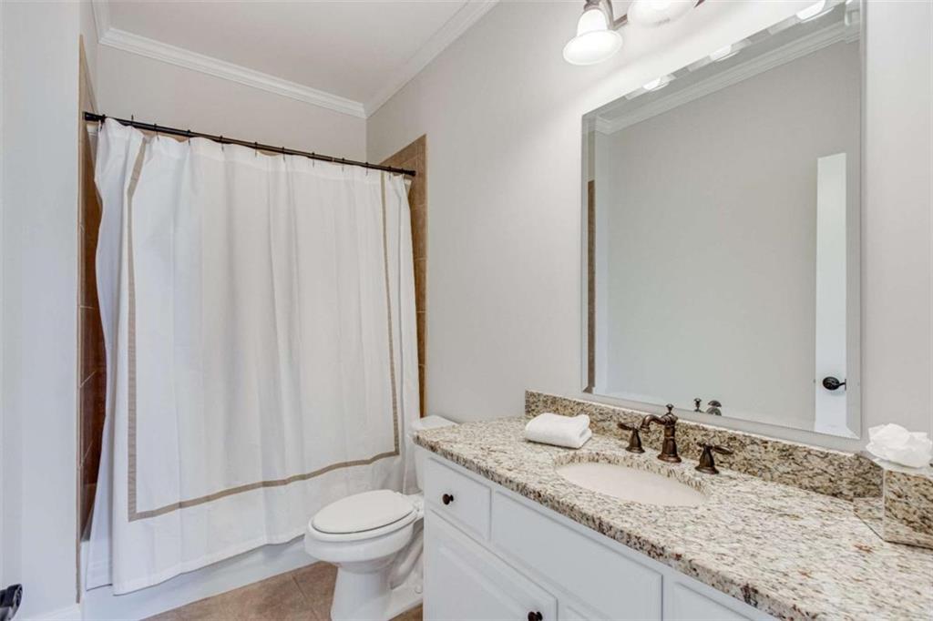 6226 Random Winds Bluff Gainesville, GA 30506 - Photo 49 of 76 a bathroom with a granite countertop sink and a mirror