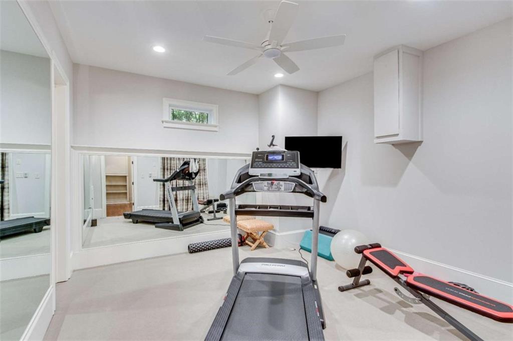 6226 Random Winds Bluff Gainesville, GA 30506 - Photo 59 of 76 a room with gym equipment and a flat screen tv