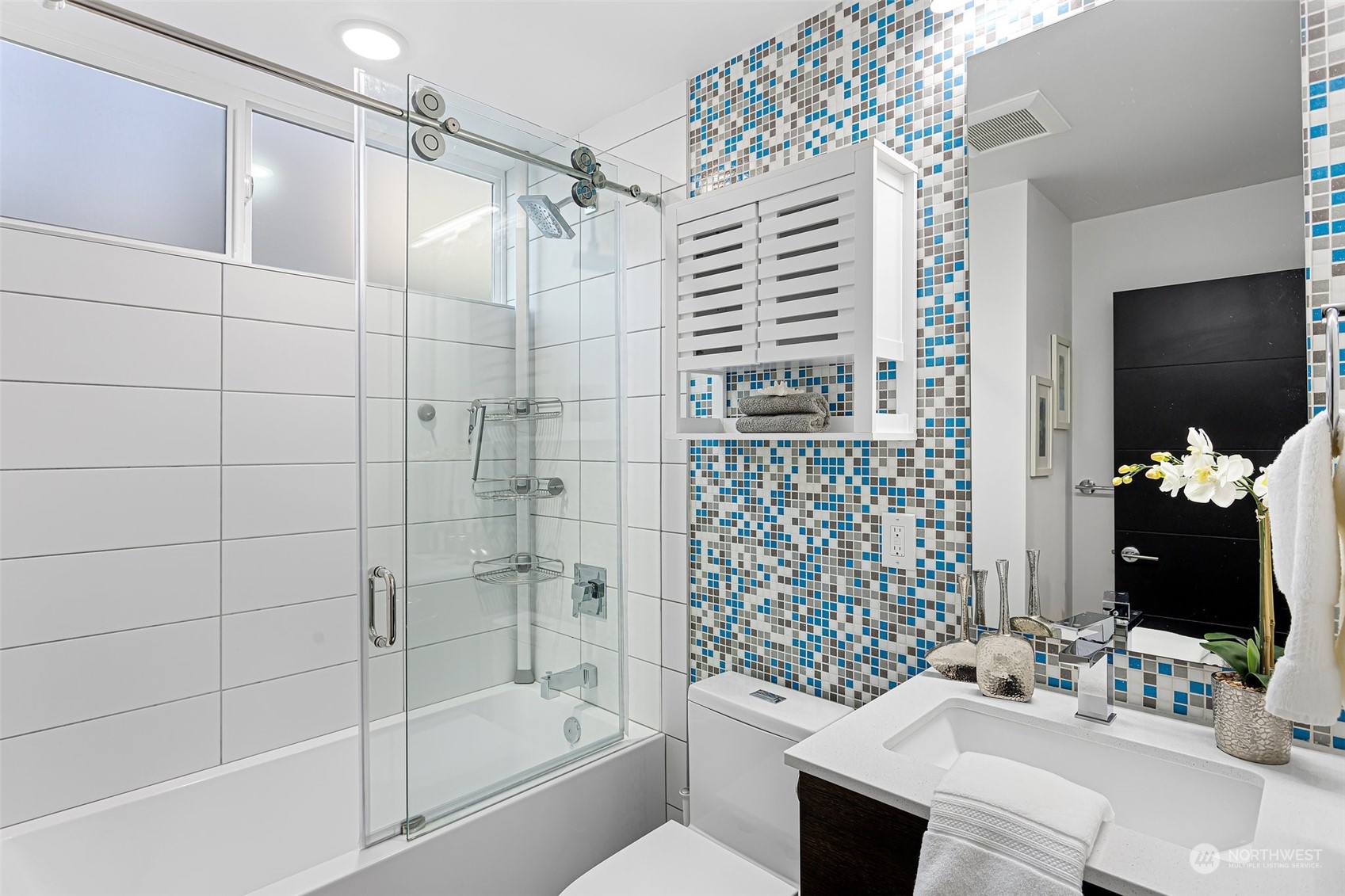 9221 Linden Avenue North, Unit B Seattle, WA 98103 - Photo 12 of 18 a bathroom with a sink toilet and shower