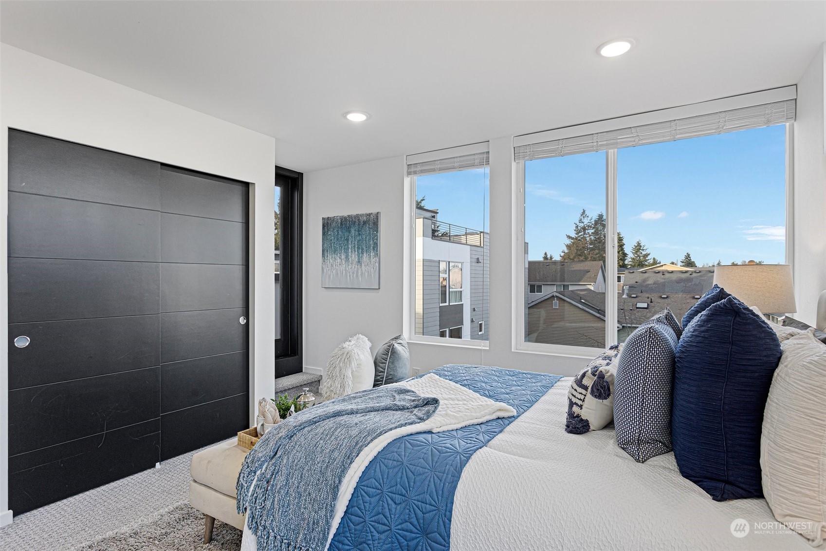 9221 Linden Avenue North, Unit B Seattle, WA 98103 - Photo 14 of 18 a bedroom with a bed and glass door
