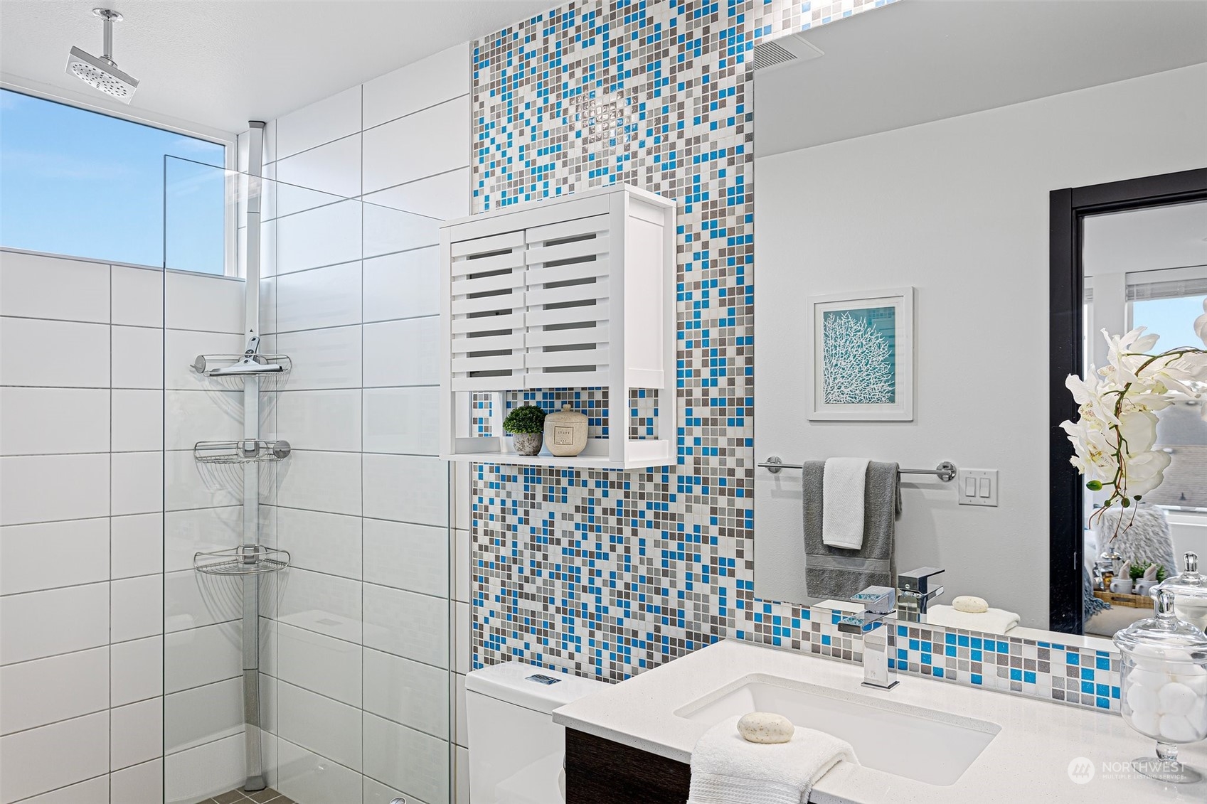 9221 Linden Avenue North, Unit B Seattle, WA 98103 - Photo 16 of 18 a bathroom with a sink and a shower