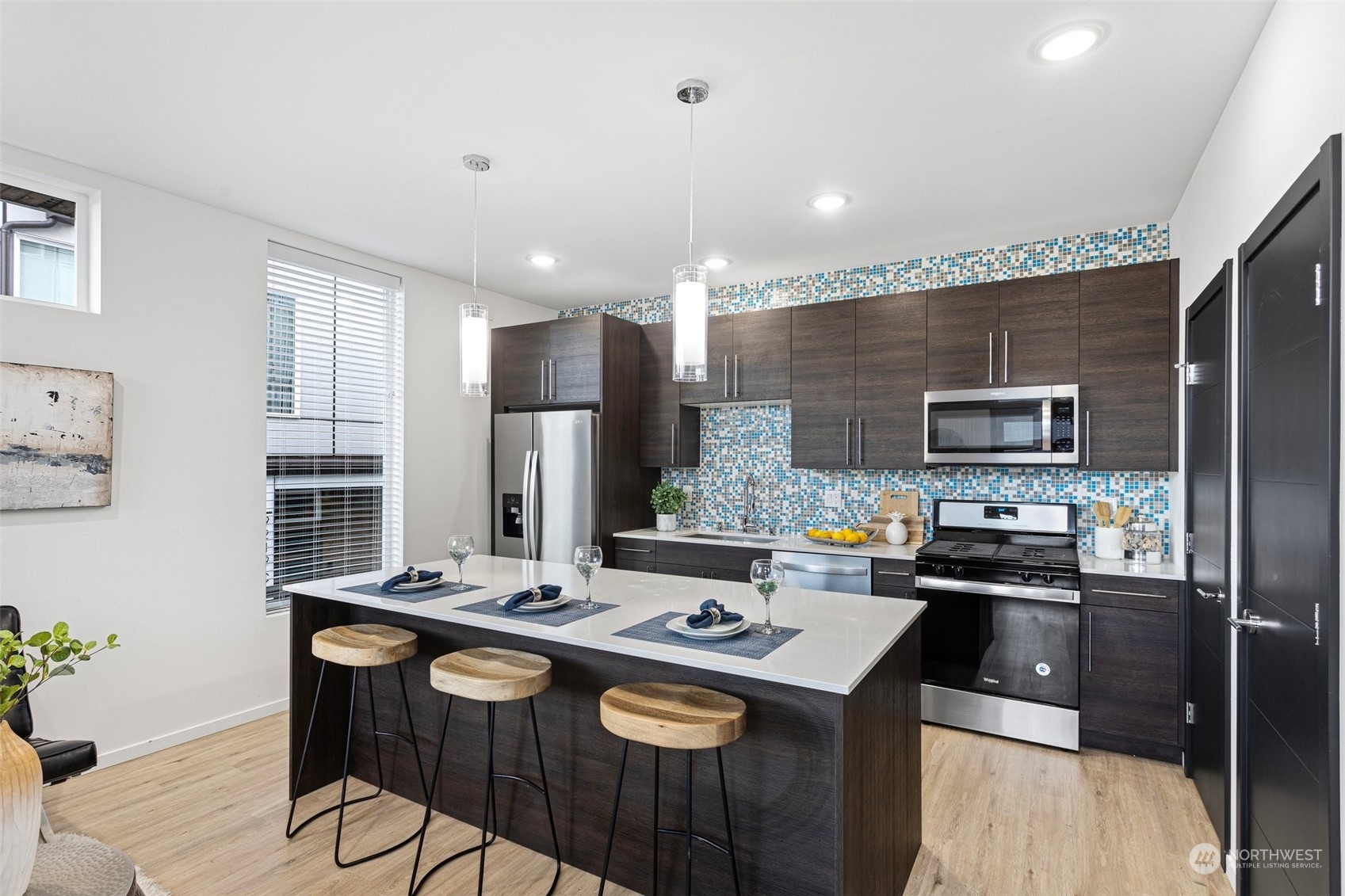 9221 Linden Avenue North, Unit B Seattle, WA 98103 - Photo 5 of 18 a kitchen that has a counter space and appliances