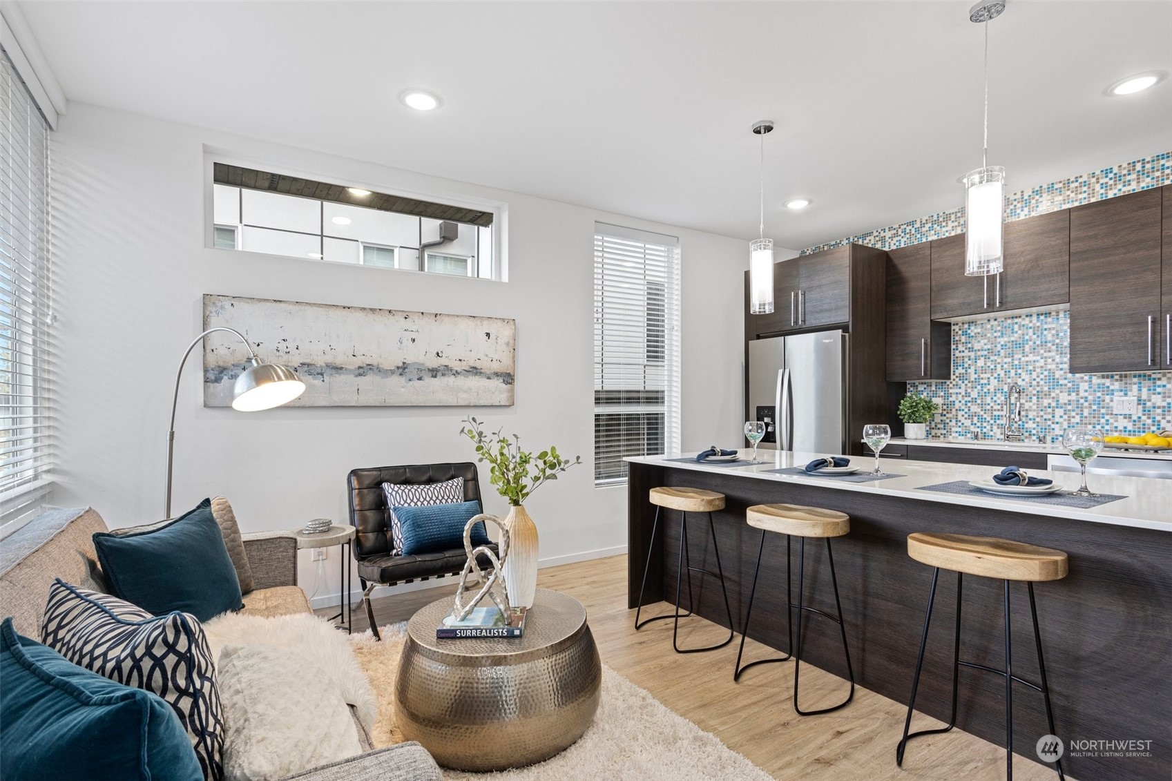 9221 Linden Avenue North, Unit B Seattle, WA 98103 - Photo 6 of 18 a kitchen with stainless steel appliances granite countertop a sink and a stove
