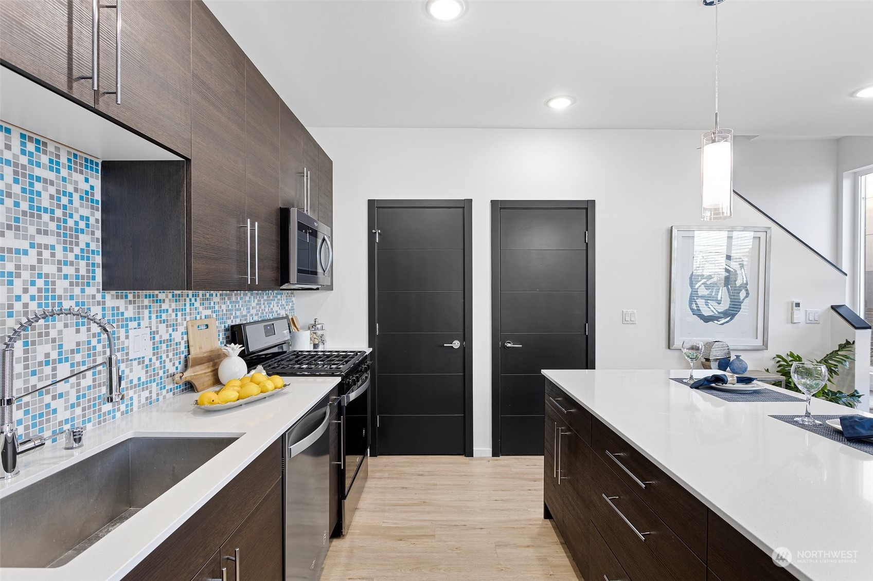 9221 Linden Avenue North, Unit B Seattle, WA 98103 - Photo 8 of 18 a kitchen with stainless steel appliances granite countertop a sink stove and refrigerator