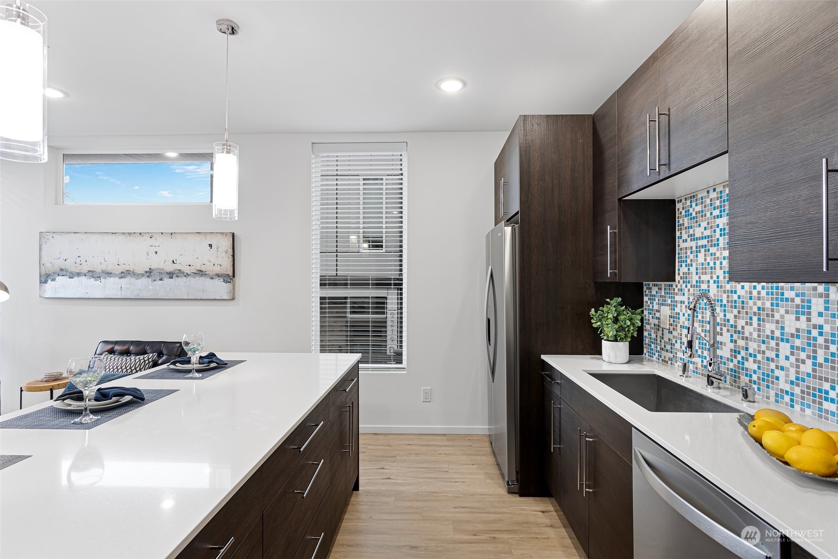 9221 Linden Avenue North, Unit B Seattle, WA 98103 - Photo 9 of 18 a kitchen with stainless steel appliances a sink stove and refrigerator