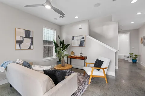 a living room with furniture and wooden floor