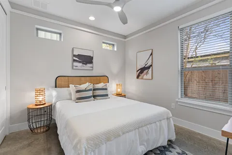 a bedroom with a large bed and a window