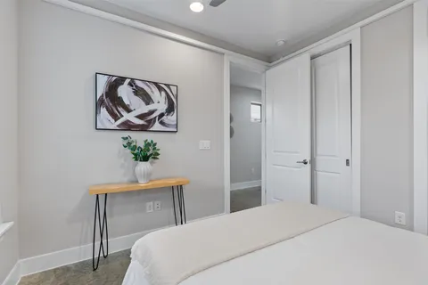 a bedroom with a bed and a painting on the wall