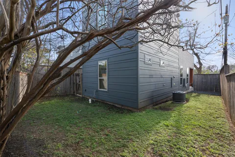 a view of a backyard with a large tree