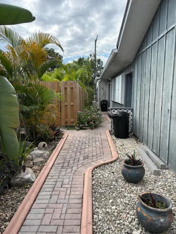 a view of a patio with chairs and plants