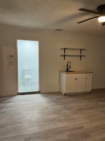 a view of a room with wooden floor and cabinet