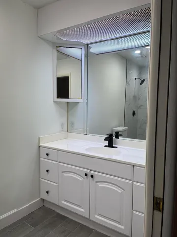 a bathroom with a sink and a mirror