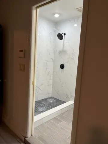 a bathroom with a glass shower door