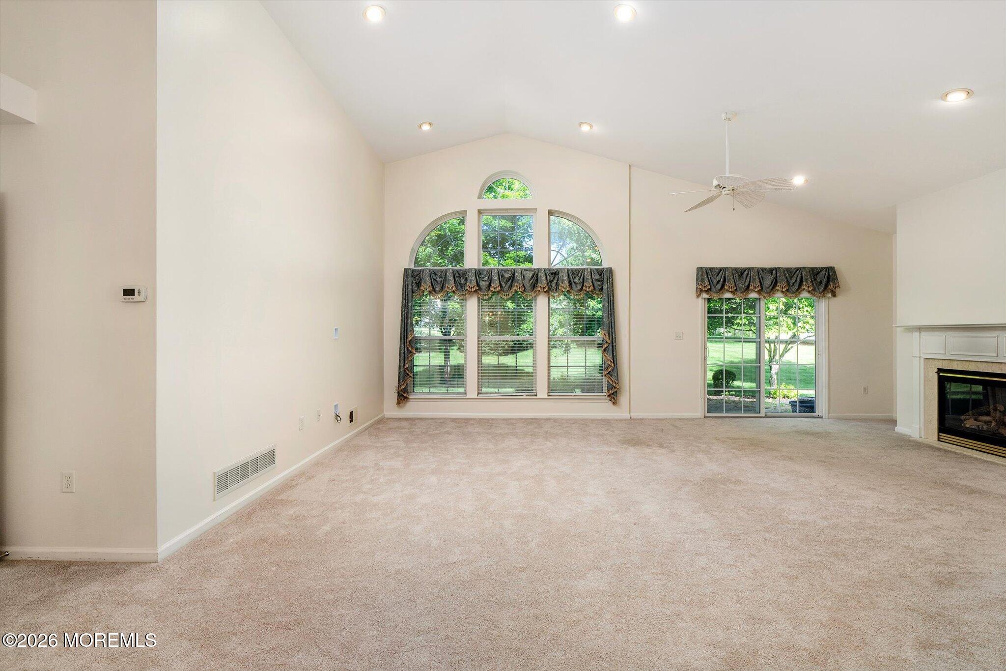 10 Powderhorn Way Allentown, NJ 08501 - Photo 6 of 27 a view of an empty room with a fireplace and a window
