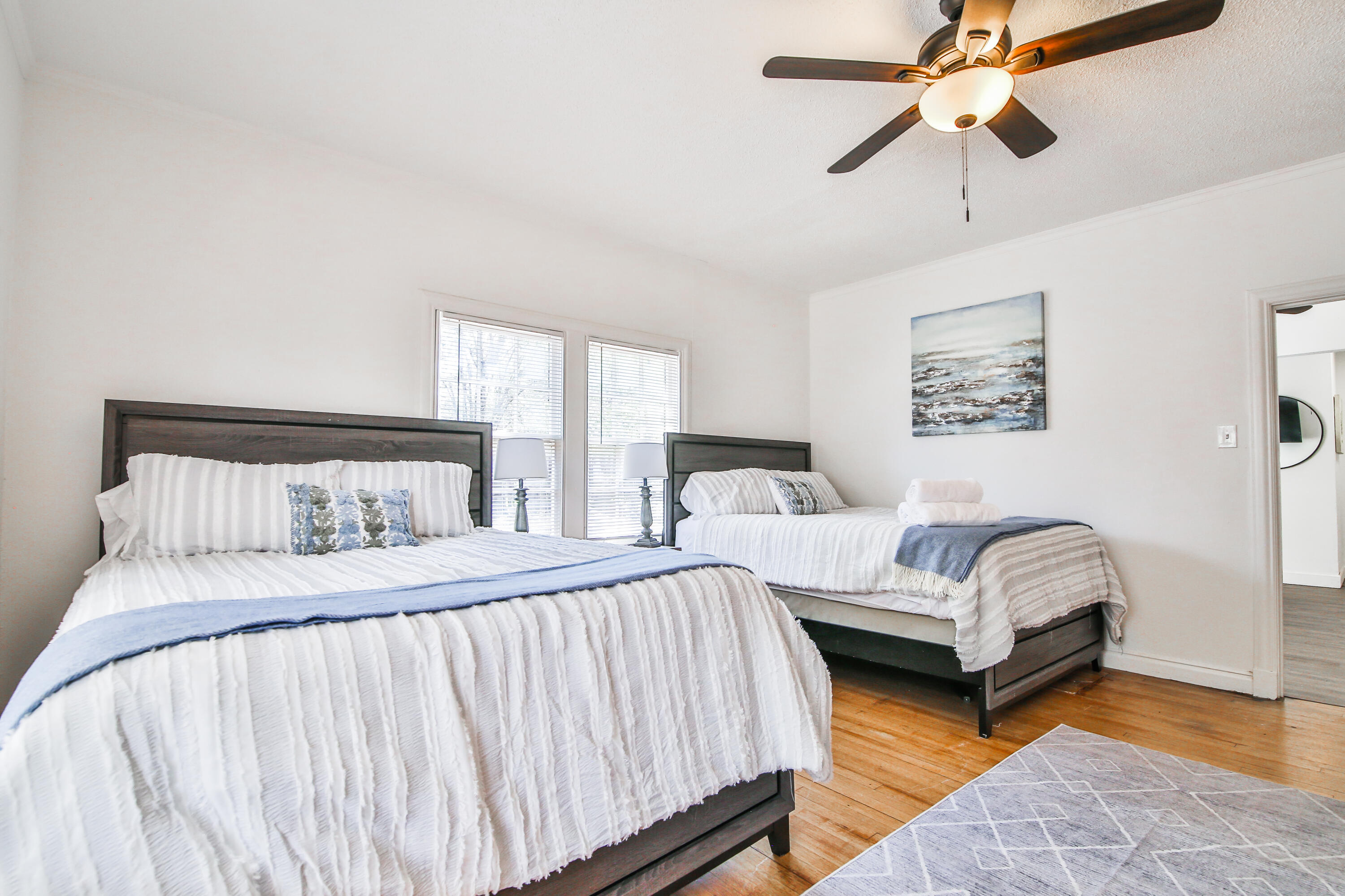 2309 17th Street Lubbock, TX 79401 - Photo 13 of 26 a bedroom with bed and a chandelier
